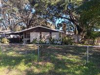 Ranch-style home with carport and fenced yard at 5017 Cornell St, Lakeland, FL 33810