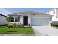 Single-story home with a two-car garage and well-maintained landscaping at 535 Noble Ave, Davenport, FL 33837