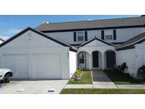 Two-story house with attached two-car garage and landscaped walkway at 1100 Lowry Ave # 51, Lakeland, FL 33801