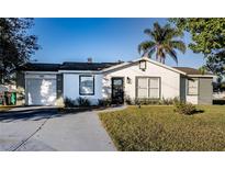 Charming single story home with a landscaped lawn and attached garage at 315 Lauderdale Ct, Kissimmee, FL 34759