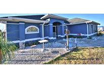 Charming one-story home with landscaped yard and blue exterior at 135 Mi Rancho Rd, Davenport, FL 33837