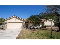 Charming single-story home with attached garage and landscaped front yard at 218 College Grove Ne Cir, Winter Haven, FL 33881