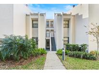 Condo building exterior with walkway and landscaping at 603 Sweet Bay Cir # 603, Winter Haven, FL 33884
