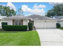 White single-story house with a two-car garage and well-manicured lawn at 723 Canberra Rd, Winter Haven, FL 33884