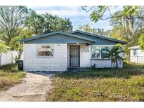 Cute one-story house with a landscaped yard and a driveway at 1244 W 9Th St, Lakeland, FL 33805