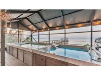 Relaxing hot tub with lake view from a covered patio at 1769 S Lake Reedy Blvd, Frostproof, FL 33843