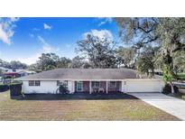 Ranch-style home with brick accents and a spacious yard at 203 E Orange St, Davenport, FL 33837