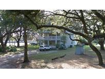 Two story house with a carport and a large oak tree in the front at 1190 S Goodman Rd, Champions Gate, FL 33896