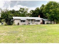 Single story home with a metal roof and large yard at 3801 Us Highway 17 92 N, Davenport, FL 33837
