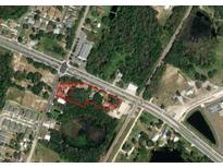 Aerial view of a vacant lot near roads and other buildings at 607 Ronald Reagan Pkwy, Davenport, FL 33896