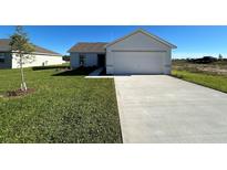 Single-story house with attached garage and well-maintained lawn at 2137 Emma Ln, Lake Wales, FL 33859