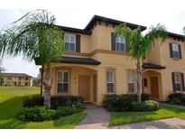 Two-story townhome with landscaping and walkway at 3001 Calabria Ave, Davenport, FL 33897