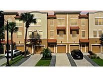 Three story townhouses with garages and palm trees at 5002 Tideview Cir # 3, Orlando, FL 32819