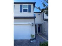 Two-story townhome with attached garage and paver driveway at 15121 Willow Arbor Cir, Orlando, FL 32824