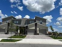 Modern three-unit townhouse building exterior at 1097 Splash Shot # 1097, Davenport, FL 33896