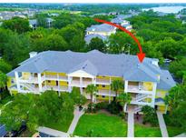Attractive yellow condo building with lush landscaping and convenient parking at 716 Lucaya Loop # B1/U716, Davenport, FL 33897
