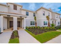 Two-story townhome with modern facade and landscaping at 8982 Stinger Dr, Champions Gate, FL 33896