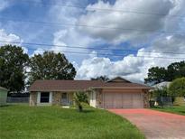 Single-story home with brown roof and stone accents at 307 Chiquita Ct, Kissimmee, FL 34758