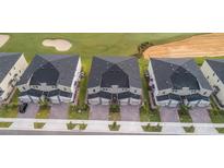 Aerial view of new townhouses with a golf course nearby at 785 Ocean Course Ave # 785, Davenport, FL 33896