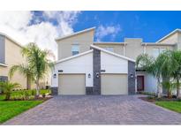 Modern two-story townhome with two-car garage and paver driveway at 1193 Drop Ln # 1193, Davenport, FL 33896