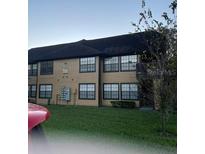 Exterior view of a two-story building with multiple units and a grassy lawn at 375 Lakepointe Dr # 101, Altamonte Springs, FL 32701