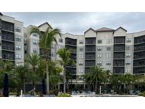 Apartment building exterior with pool and palm trees at 14501 Grove Resort Ave # 1318, Winter Garden, FL 34787