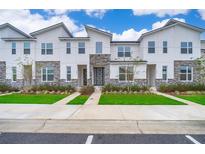 Modern townhouses with stone accents and landscaped yards at 1852 Tropical Palms Cir, Kissimmee, FL 34747