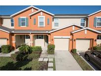 Two-story townhome with attached garage and landscaping at 3171 Tocoa Cir, Kissimmee, FL 34746
