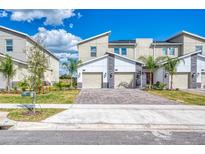 Modern townhouse exterior with paver driveway at 891 Ocean Course Ave # 0, Davenport, FL 33896