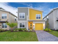 Two-story home with gray and yellow exterior at 2811 Bookmark Dr, Kissimmee, FL 34746