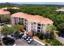 Aerial view of the apartment building and surrounding area at 8010 Tuscany Way # 3103, Davenport, FL 33896