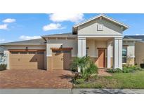 Two-story house with a two-car garage and brick driveway at 2686 Meadowedge Loop, Saint Cloud, FL 34772