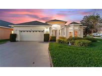 Inviting one-story home with a two-car garage and well-manicured lawn at 100 Moss Ln, Davenport, FL 33837