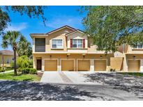 Front view of three-unit townhome building with garages at 2732 Oakwater Dr # 101, Kissimmee, FL 34747
