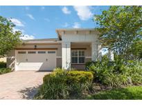 House exterior featuring a two-car garage and landscaping at 4921 Catalpa Dr, St Cloud, FL 34772