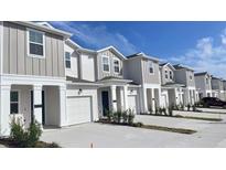 Modern townhouses with attached garages and landscaping at 7645 Danube Rd, Kissimmee, FL 34747