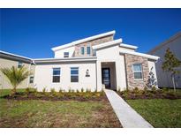 Modern two story home with stone accents and landscaping at 4577 Target Blvd, Kissimmee, FL 34746