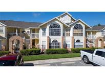 Two-story condo building with brick accents and landscaping at 5014 Laguna Bay Cir # 108, Kissimmee, FL 34746
