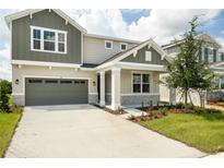 Two-story house with gray and green exterior at 155 Bull Frog Ln, Umatilla, FL 32784