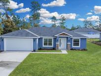 Newly built home with a two-car garage and landscaped yard at 16617 Sw 31St Cir, Ocala, FL 34473