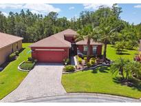 Red two-story house with paved driveway and landscaping at 806 Ebb Tide Ln, Poinciana, FL 34759