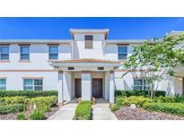 Front view of two-story townhome with landscaping at 8919 Stinger Dr, Davenport, FL 33896