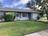 Ranch style home with well-manicured lawn and attached garage at 101 Albert St, Winter Springs, FL 32708