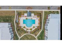 Resort-style pool with plenty of lounge chairs and a covered seating area at 3191 Paradox Cir # 205, Kissimmee, FL 34746