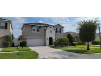 Two-story house with attached garage and landscaping at 2391 Beacon Park Landing Cir, Orlando, FL 32824