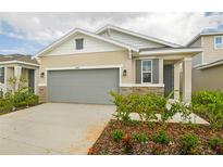One-story house with gray garage door and landscaping at 6349 Clover St, Lake Hamilton, FL 33851