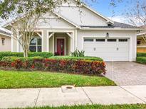 One-story home with red door and white garage at 2516 Pickett Ave, Saint Cloud, FL 34772