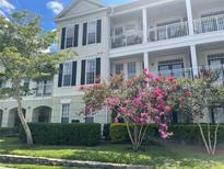 Three story building with balconies and landscaping at 239 Longview Ave # 107, Celebration, FL 34747