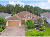 Single Gathering home with two car garage and manicured lawn at 694 Irvine Ranch Rd, Kissimmee, FL 34759