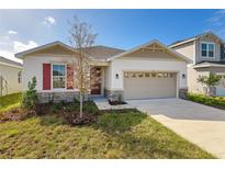 Single-story house with a beige exterior and red shutters at 171 Bull Frog Ln, Umatilla, FL 32784